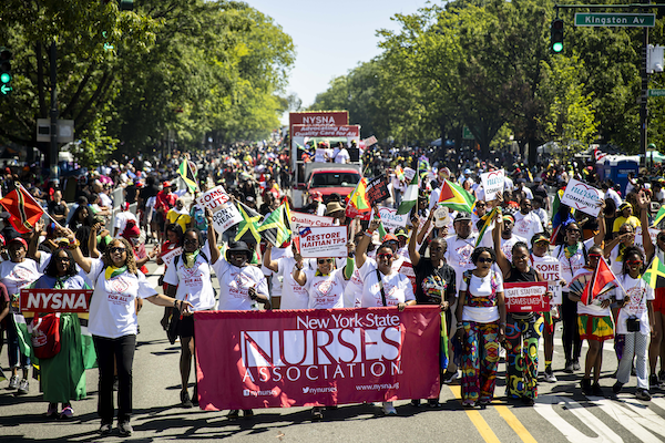 NYSNA members carry a NYSNA banner in the West Indian American Day Parade in NYC.